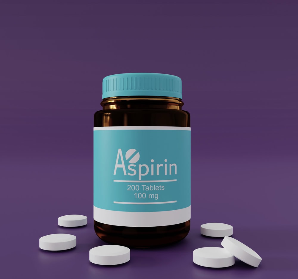 A brown bottle labeled "Aspirin 200 Tablets 100 mg" with a blue cap is surrounded by several white tablets on a purple surface.